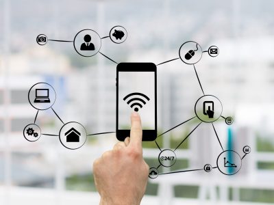 composite of hand using smartphone with graphics